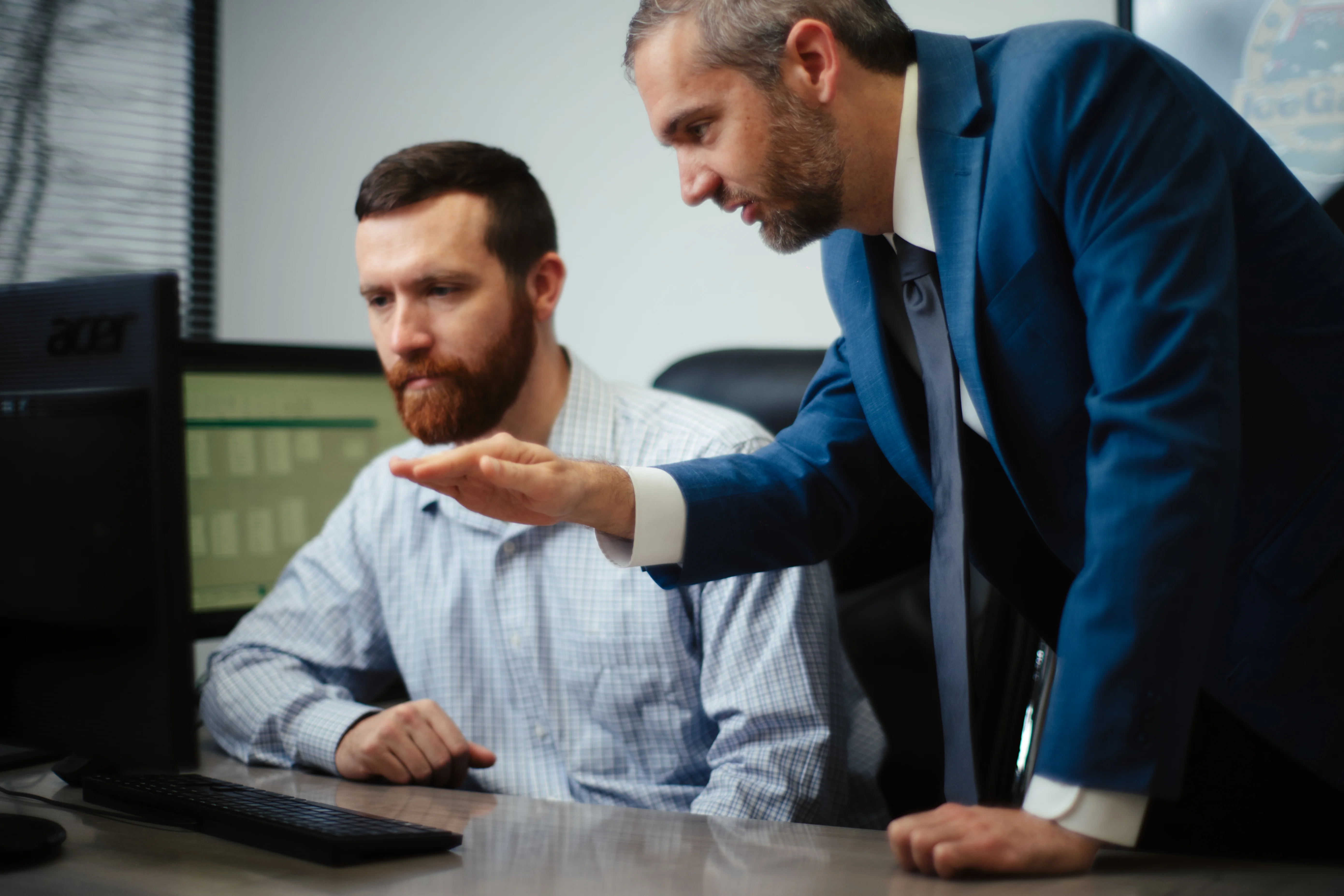 Team reviewing data on a desktop monitor